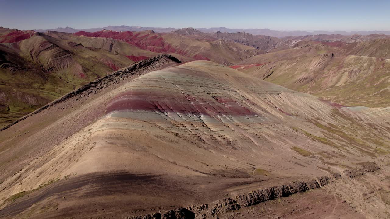 은색, 초록색, 갈색의 활기찬 층은 밝은 파란 하늘 아래 페루의 산맥의 놀라운 풍경을 만니다.