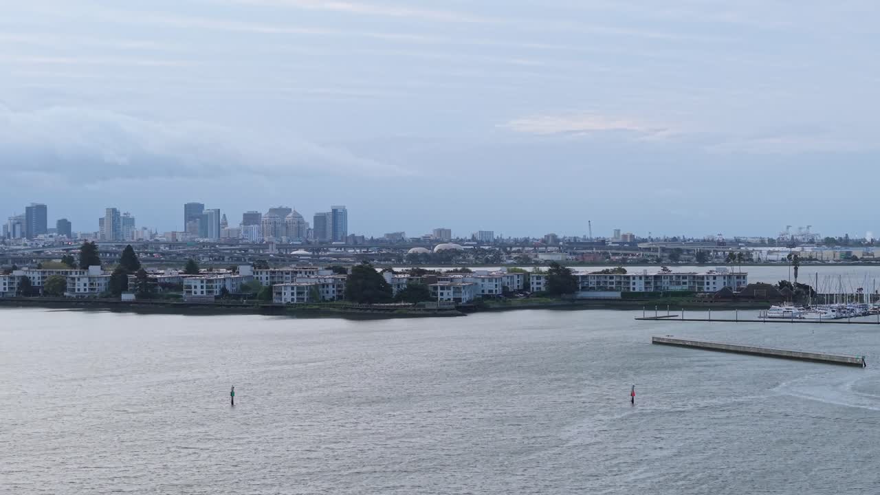 Aerial drone footage captures the Emeryville shore with smooth zoom-out shots over the waterfront.