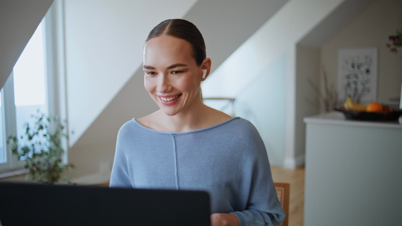 Smiling woman speaking laptop in apartment closeup. Freelancer video calling