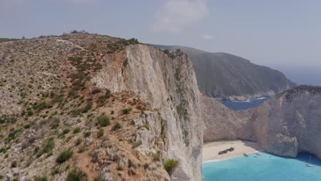 Aerial---Shipwreck-in-Zakynthos---low-pass-from-rocks-and-tilting-down