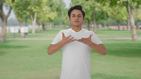 Indian-man-doing-breathe-in-breathe-out-exercise