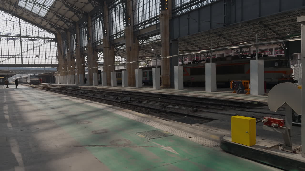 Restored Paris train station with glass roof, industrial style, and empty platforms