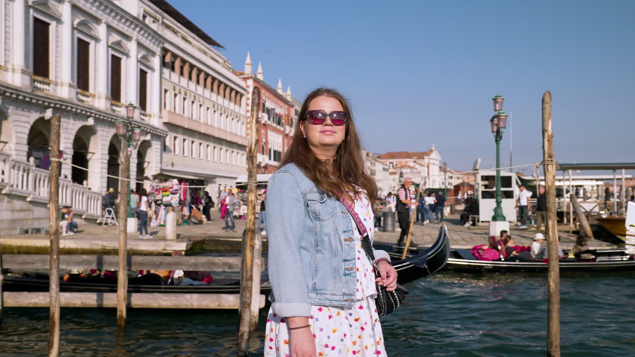 A Woman Traveler On The Pier Near Ponte della Paglia During Summer In Venice, Italy