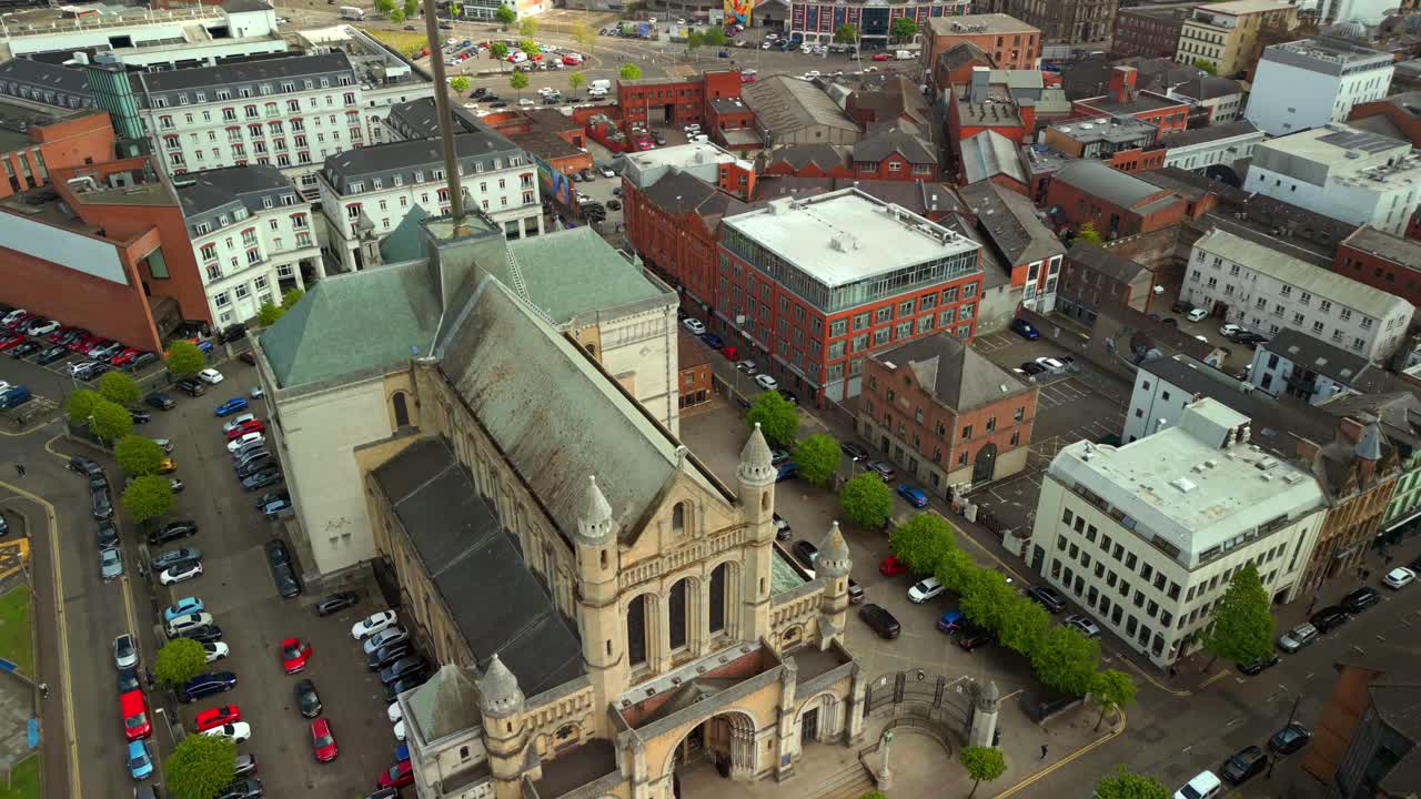 Descending aerial video of St Anne's Cathedral in the Cathedral Quarter in Belfat City Centre, Northern Ireland on a bright and sunny day. Filmed in 4K, 60FPS and with Rec709 Color.