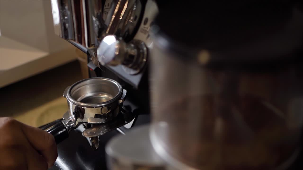 Coffee grinder grinds freshly roasted coffee beans