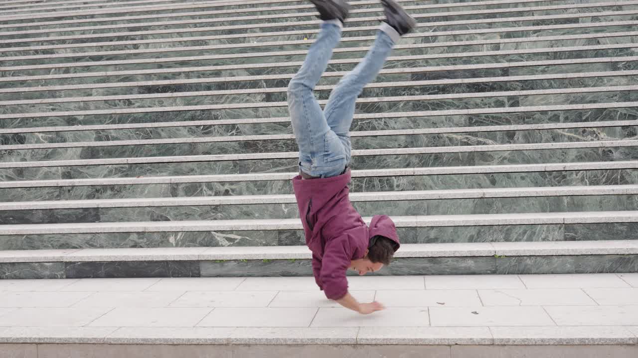 Breakdancer performing acrobatics on urban stairs
