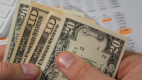 man works with dollar bills