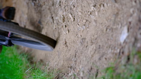 mountain biker passes by in slo mo on a dry dirt trail