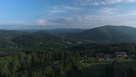 A-shot-of-beautiful-Polish-mountains-with-a-green-forest-and-a-tourist-resort-in-the-summer-in-Poland