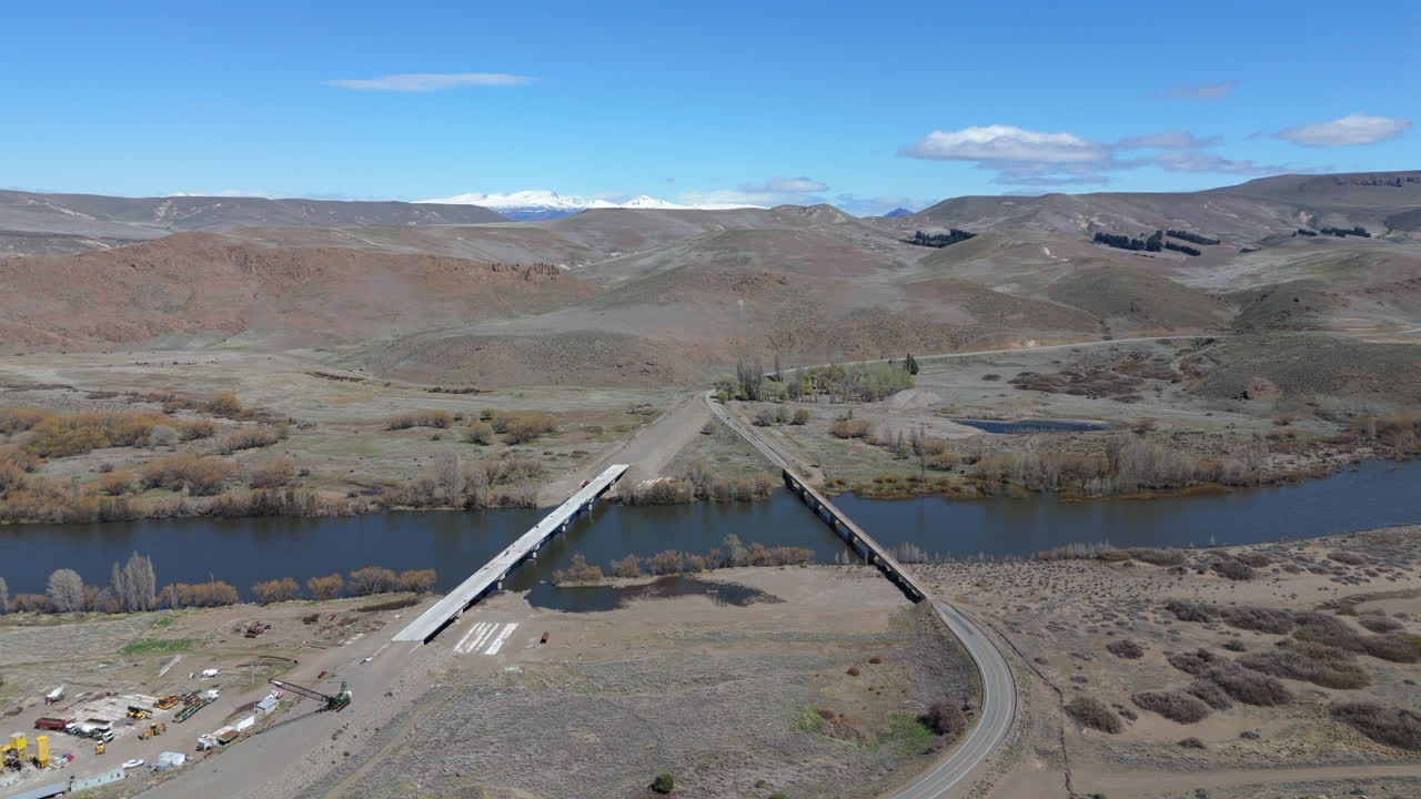 Aerial View of a Bridge over a River in a Mountainous Desert Landscape