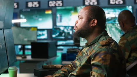 exhausted intelligence corps agent controlling drones, working overtime