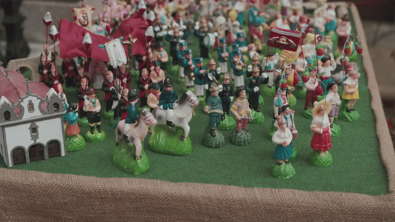 Miniature Portuguese parade scene with church, banners, costumes, and festive detail