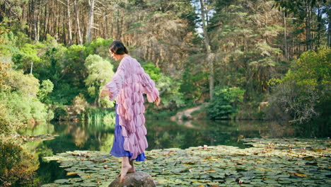 woman fairy standing water pond beautiful forest. elegant girl posing at lake