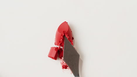 red lipstick swatches on a spatula