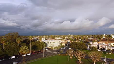 Fly-over-park-and-housing-during-a-cloudy-day,-aerial-view