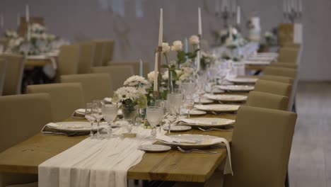 long wedding table with white flowers and candles indoors location irrelevant