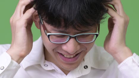 young asian businessman having headache