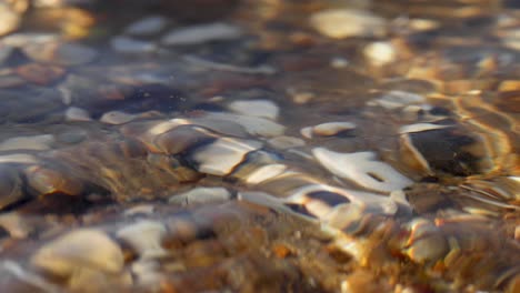 clear water rippling over colorful pebbles