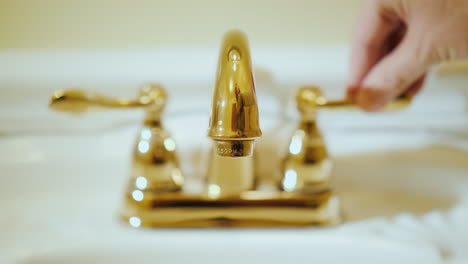 open a tap with water in a luxurious bathtub