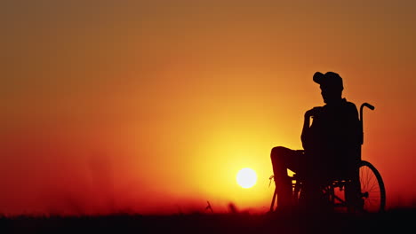 disabled person at sunset