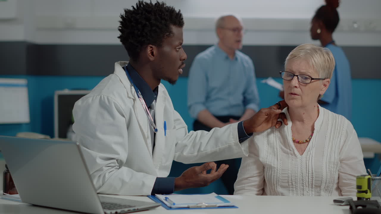 Doctor consulting with elderly patient in clinic