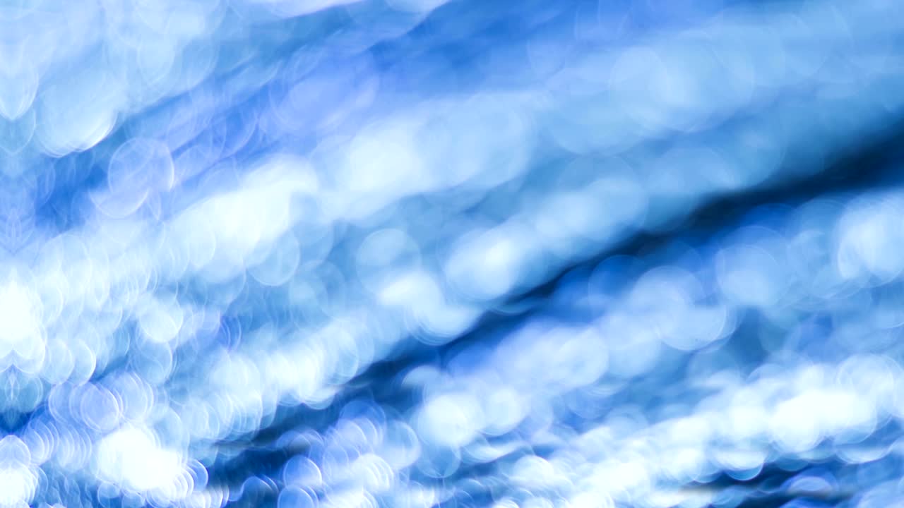 Blue bokeh. Abstract background. Defocused lights. 4K High quality footage.