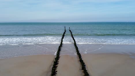 long groyne at a beach in the netherlands