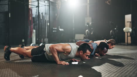 Gym,-men-and-women-in-floor-exercise-for-strong