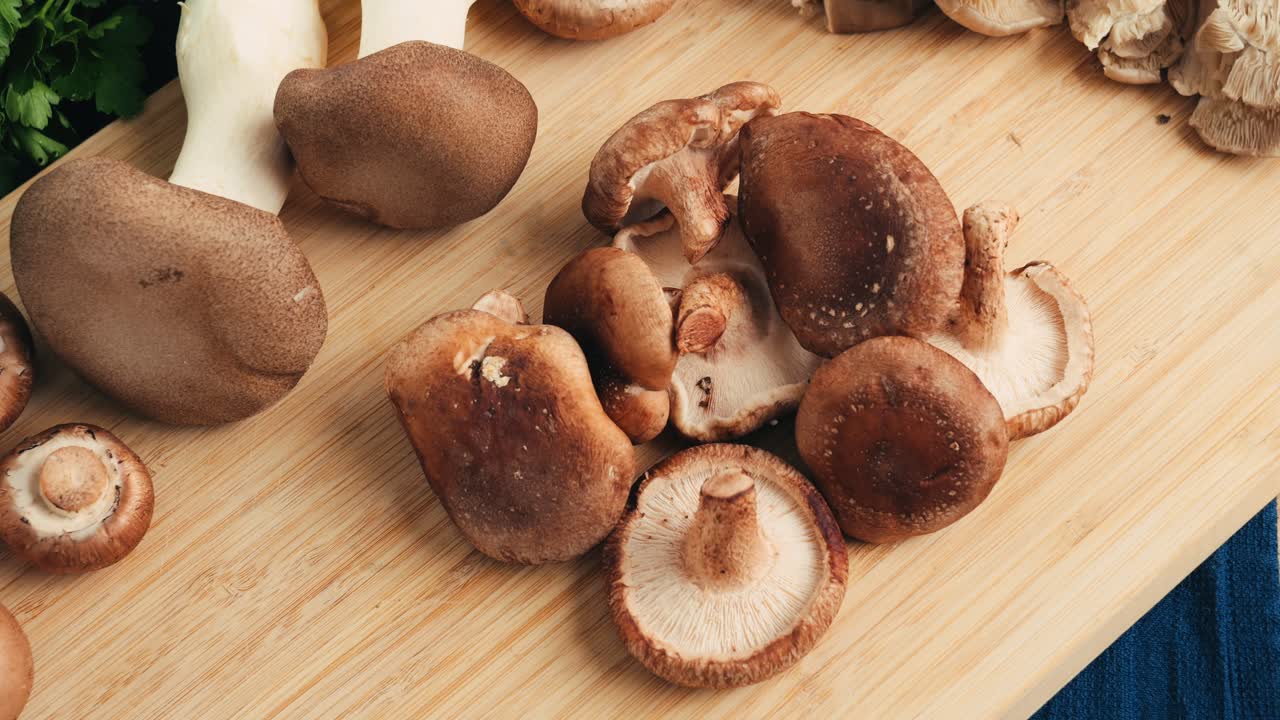 Assortment of Fresh Shiitake Mushrooms on a Wooden Cutting Board