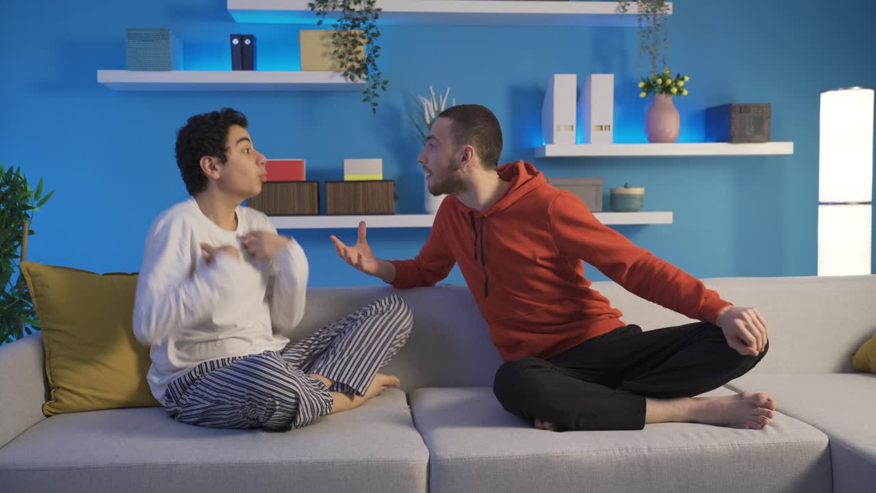 Angry men argue with emotional expressions on their faces and then they can't stand it and make up.