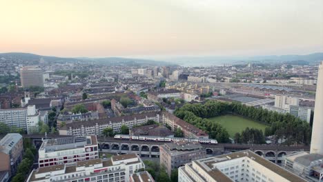 Aerial-footage-of-a-train-in-Zurich,-the-capital-and-the-largest-city-in-Switzerland