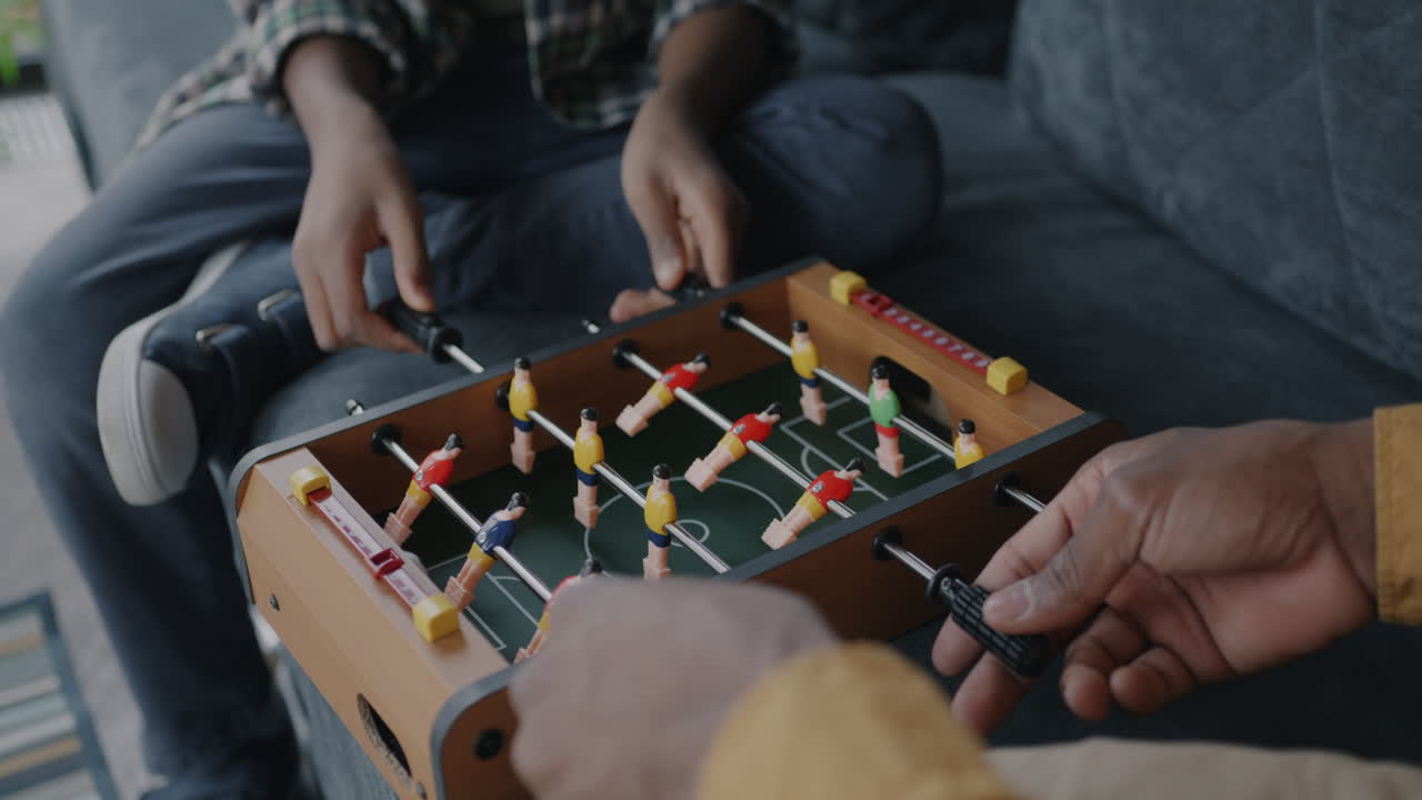 Grandson and Grandparent Playing Foosball