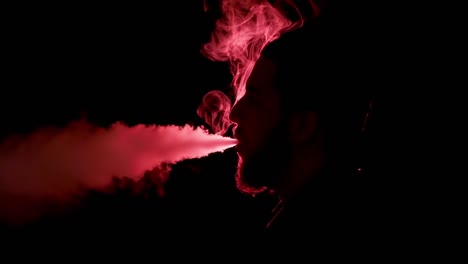 silhouette of man smoking on dark background with red light