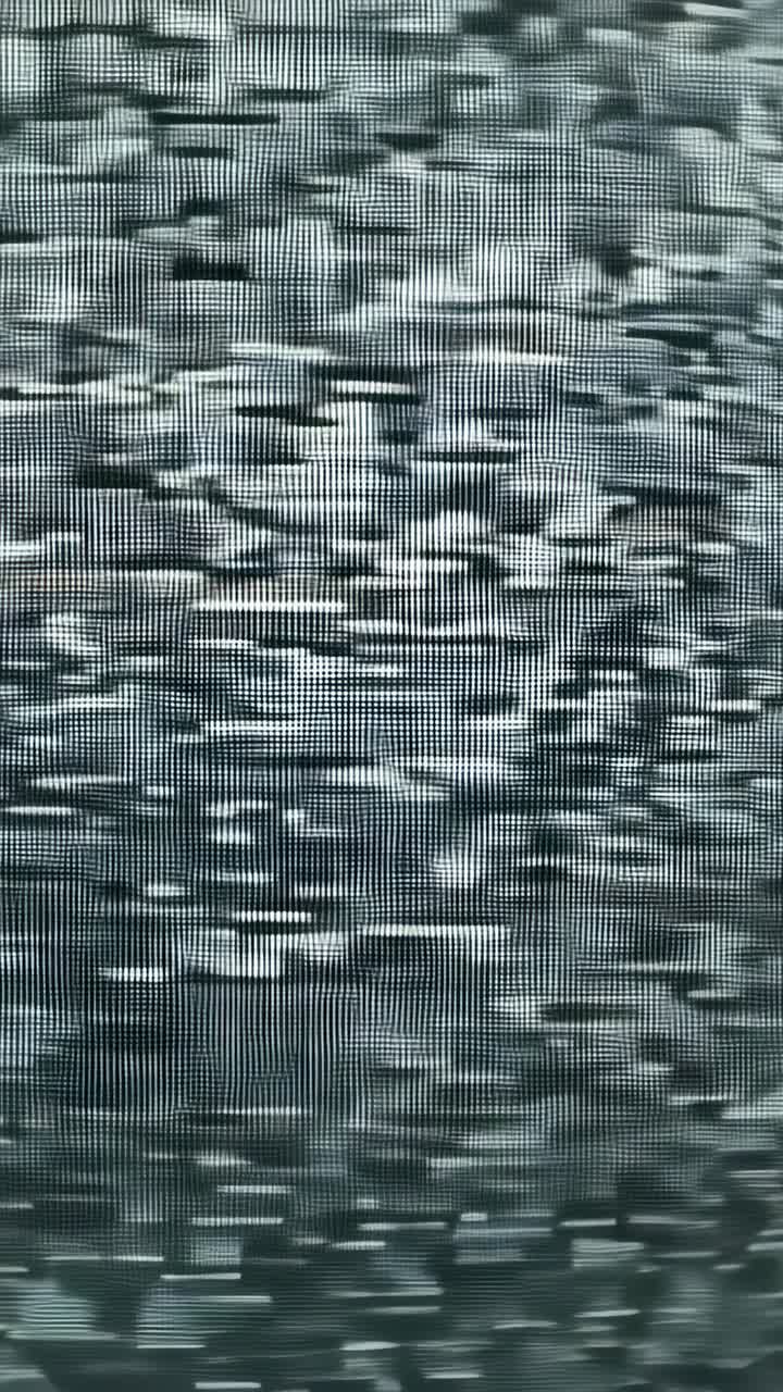 Vertical video: Starting camera zooming toward CRT TV in dark room, revealing static scan lines