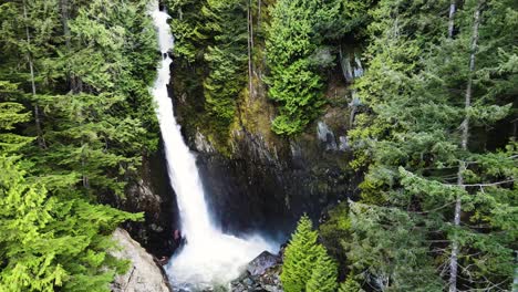 aerial pullback shot of silver falls waterfall in british columbia, canada
