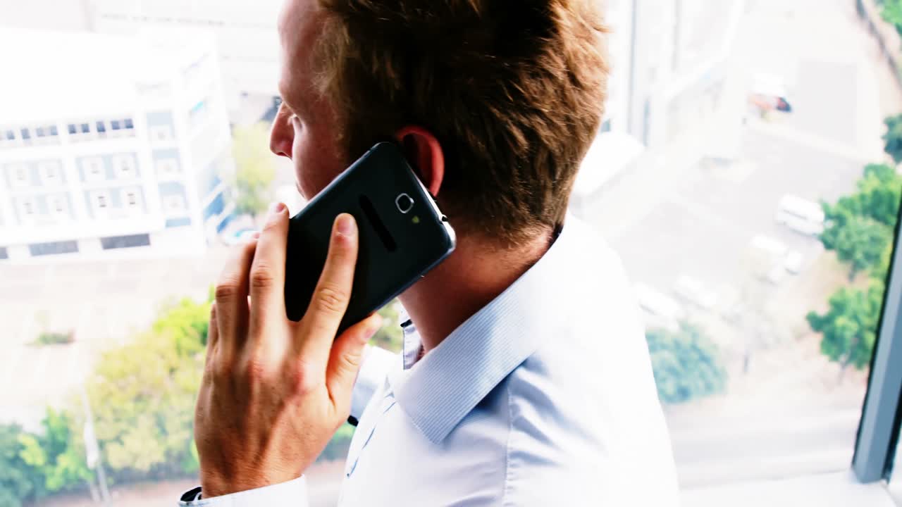 Happy executive talking on mobile phone