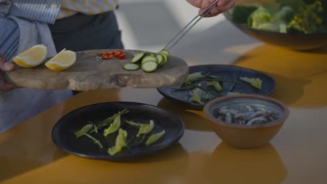 chef serving squid on outdoor table