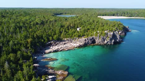 aerial establishing shot of a rocky shore in georgian bay, ontario, canada