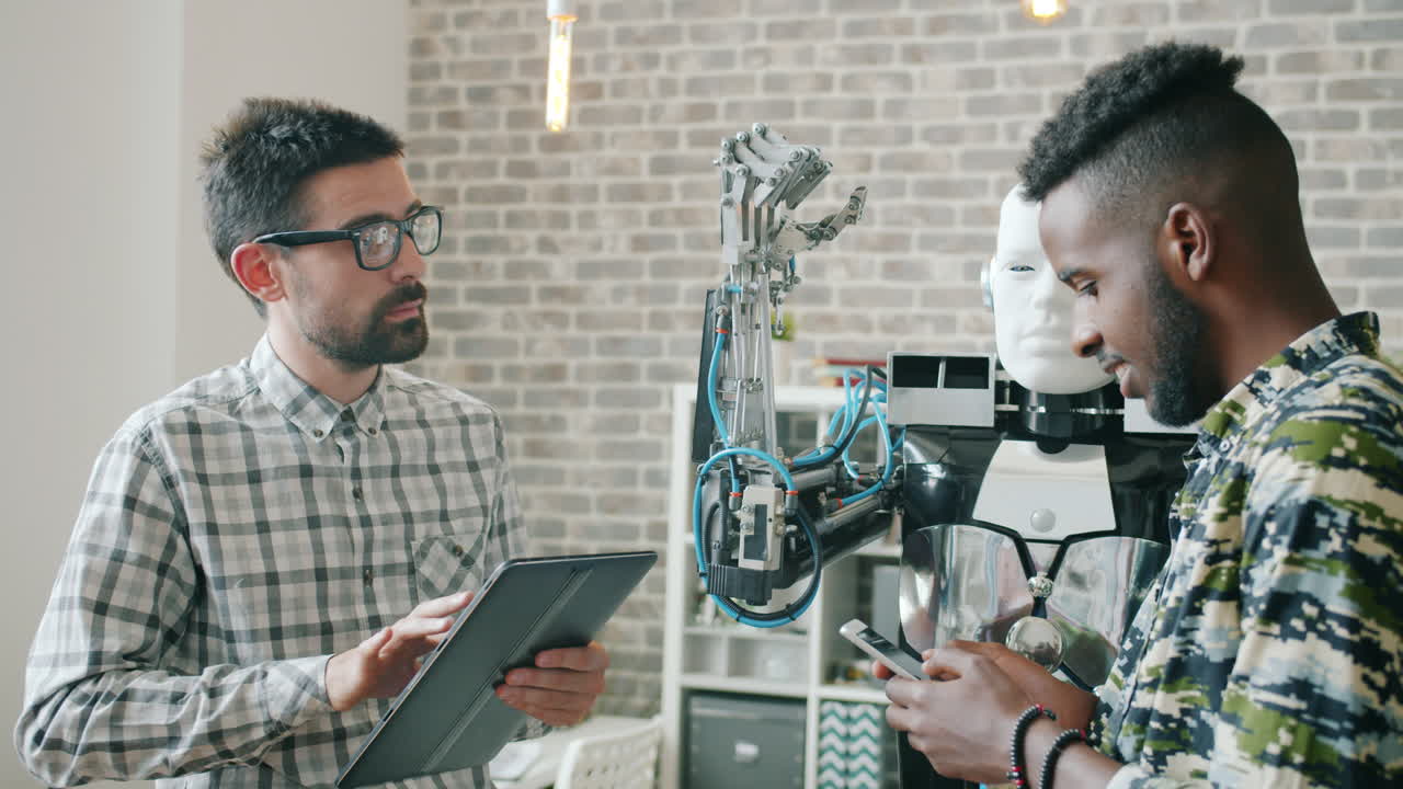 Two Men Working with a Robot