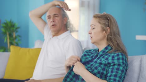 Married-couple-overwhelmed-by-the-heat-at-home.