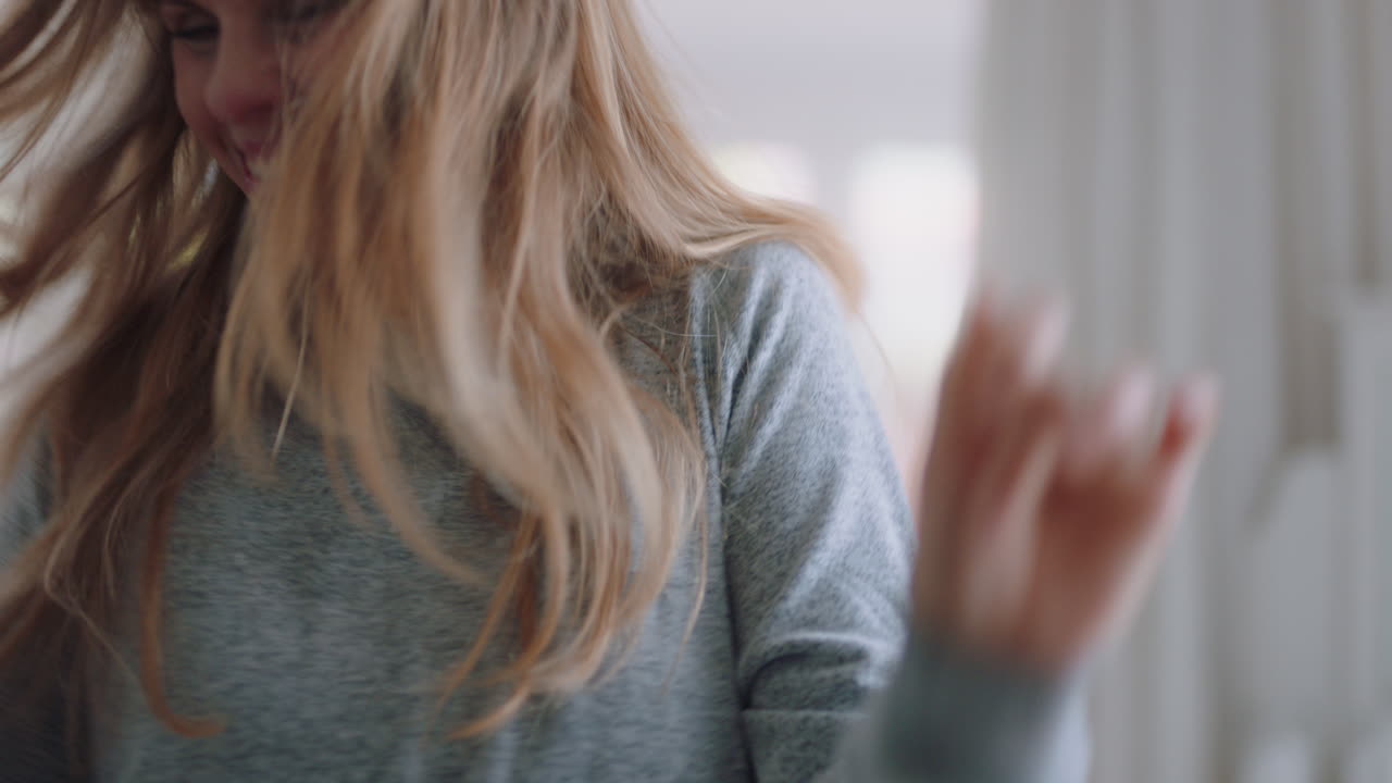 행복한 젊은 여성이 집에서 춤을 추고 주말을 축하하고 재미있는 춤을 추고 침실에서 아침에 파자마를 입고 새로운 하루를 즐기고 4k 영상을 즐기고