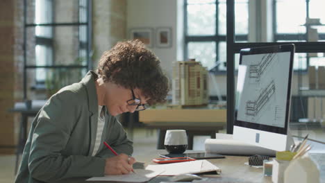 female architect working on design plans in a modern office