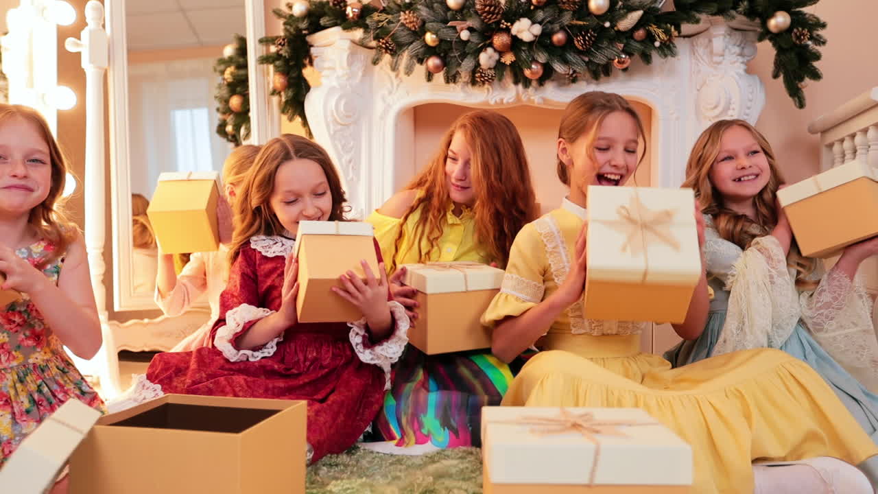 Happy smiling company of young girls rejoicing the presents. Christmas season joy and celebration.