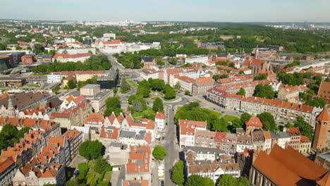 aerial flyover beautiful old town of gdansk with famous church,historic buildings and green trees in summer