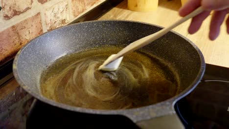 melting butter in a hot pan while preparing breakfast