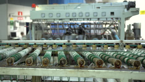 big glass panels on the factory conveyor roller in a factory