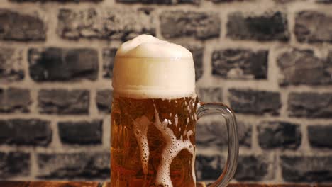 closeup of filling a glass of beer with foam overflow and slowly floating down