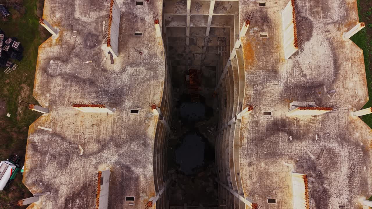 Aerial view of a crumbling structure amidst green surroundings