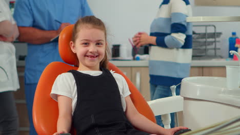portrait of little girl patient looking at camera waiting for pediatric stomatologist
