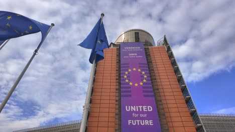 slow motion pan up of eu building with unity banner